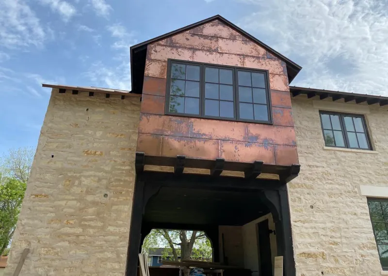 Copper metal panel facade on a stone building for Metal Roof Coating in Swanton
